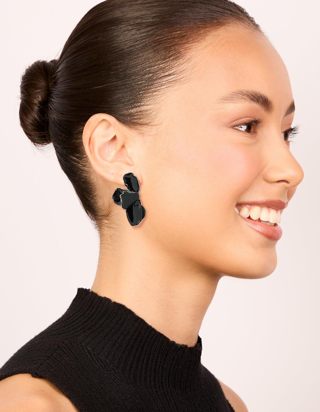 Stylish chunky mini petal drop earrings in black coated metal and silver accents on model view