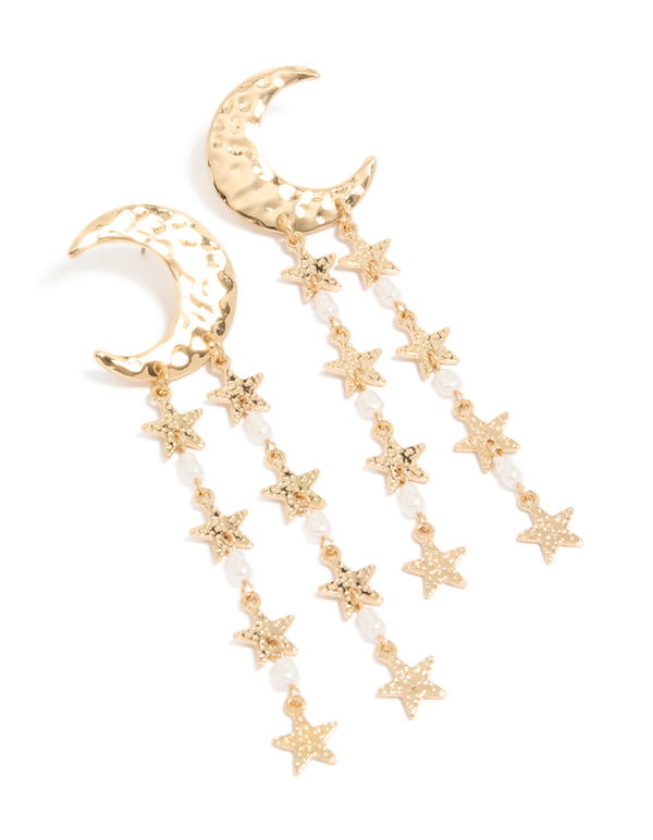 Crafted from gold metal, these crescent moon and star drop earrings feature celestial charm details with pearl beads and white accents front view