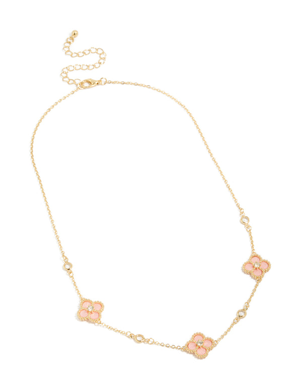 Highlighting a gold plated pink cubic zirconia flower trio necklace with dainty style close up view
