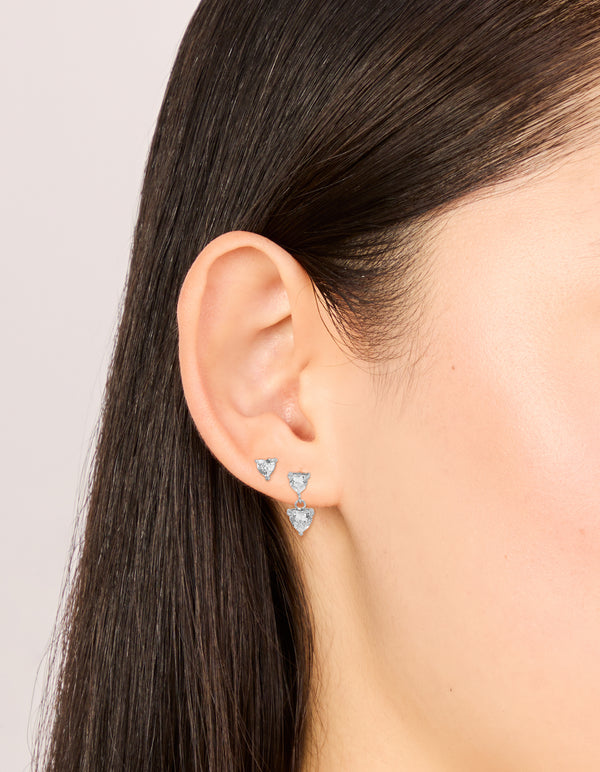 Featuring waterproof stainless steel cubic zirconia heart stud and drop earrings in a 2-pack with silver and clear tones on ear view