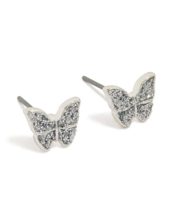 Delicate small diamante butterfly earrings in silver with glitter featuring stud closure front view