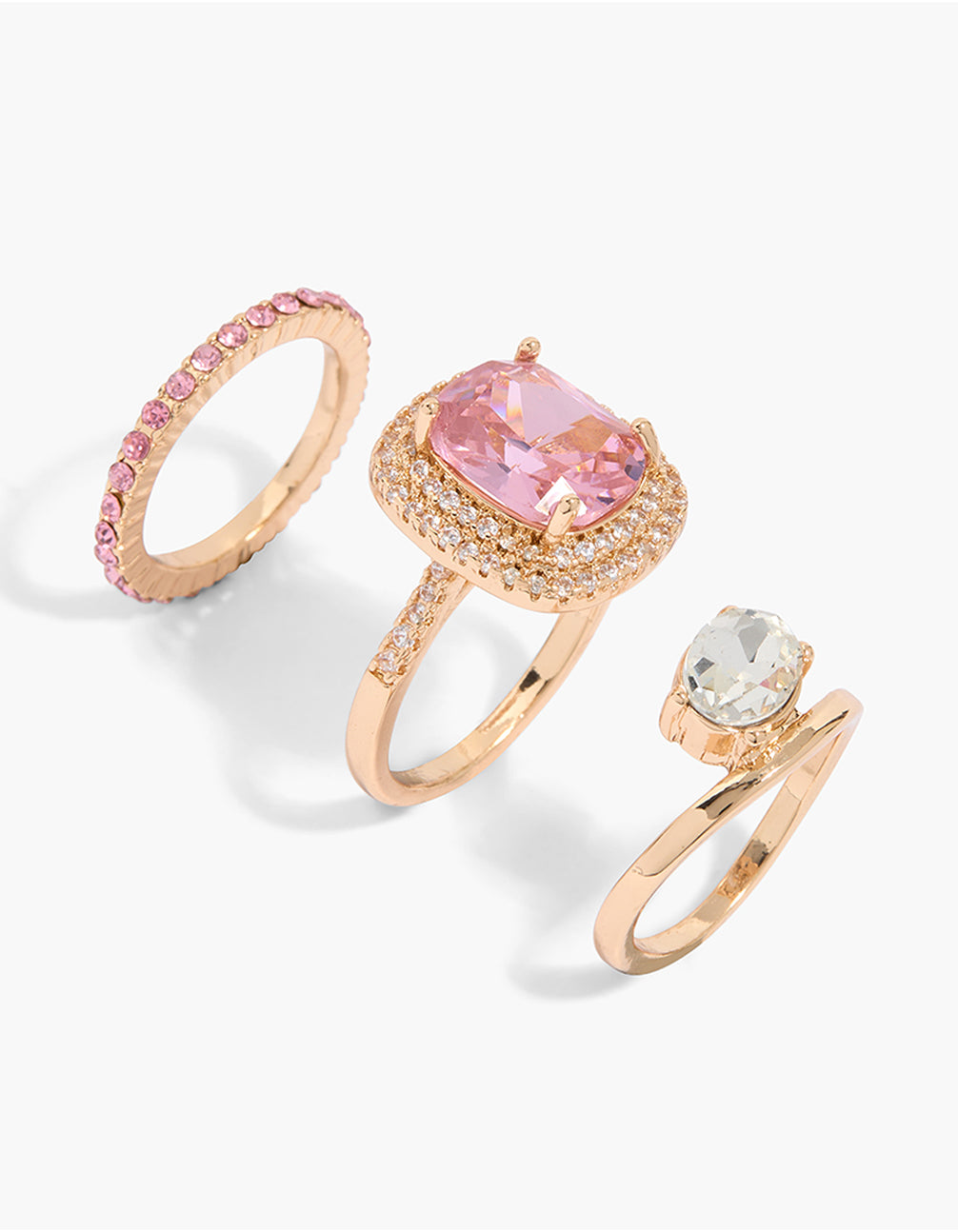 Showcasing oval stone cut cubic zirconia and crystal rings in gold, clear, pink, and white, crafted as a layered 3-pack with dainty square styling front view