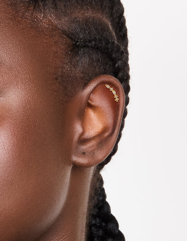 Elegant crawler stud earring featuring marquise cut cubic zirconia in gold plated titanium with flat back closure on ear view