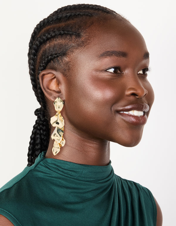 Styled statement multi petal drop earrings in gold plated finish on model view