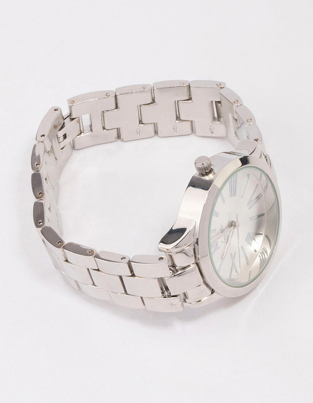 Featuring a large roman numeral watch with white dial, round shape, and link band strap in silver, designed for women's formal occasions with analog type front view