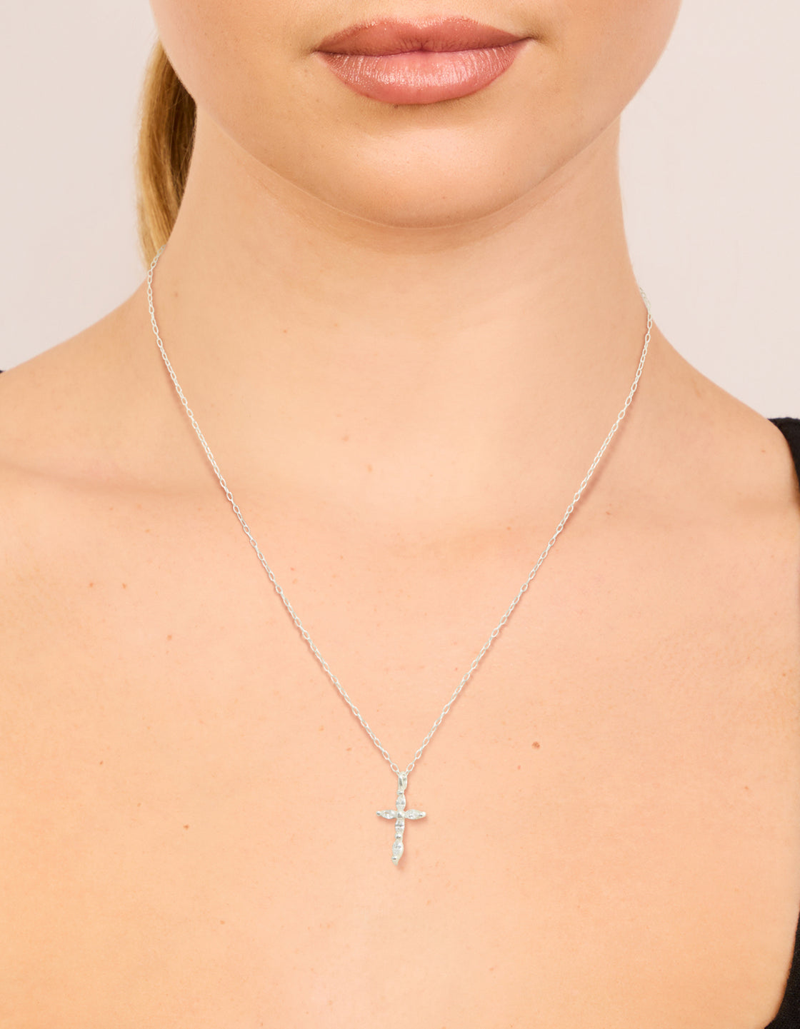 Discover this sterling silver cubic zirconia marquise cross necklace in dainty pendant style on neck view