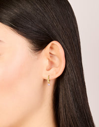 Crafted from gold plated sterling silver, these pink cubic zirconia hoop earrings on ear view - link has visual effect only