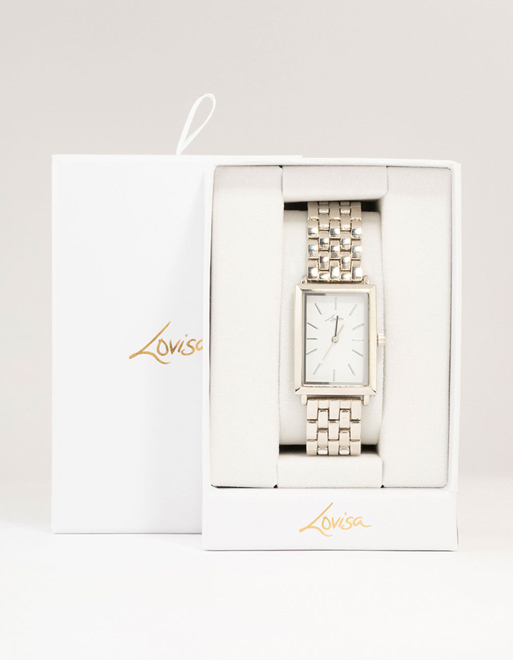 Beautifully presented silver white rectangle watch with link band designed for women featuring formal occasion styling and analog type case detail view