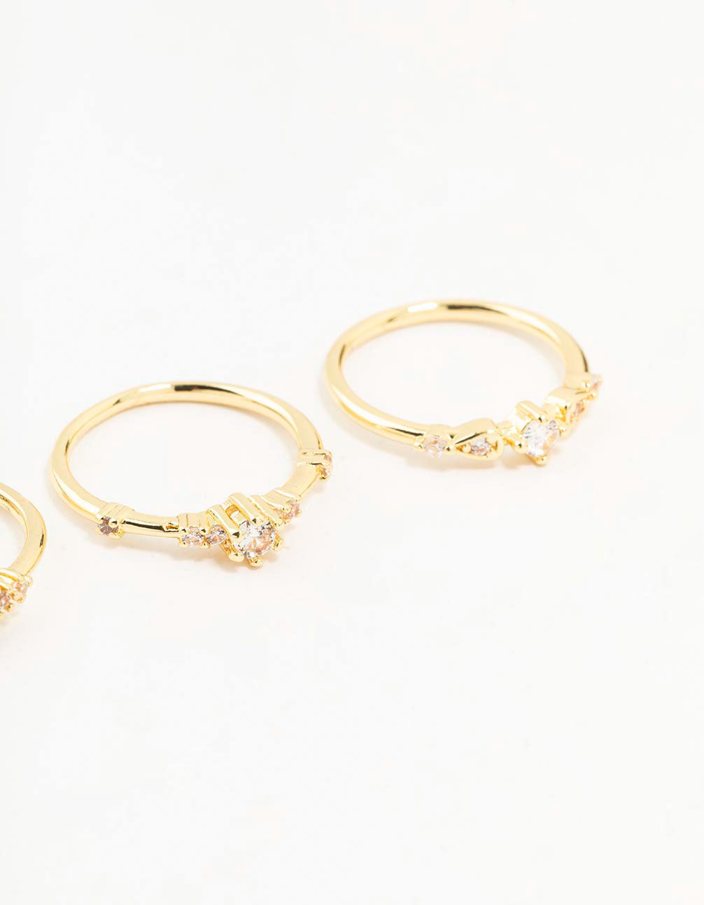 Crafted from gold plated material with dainty cubic zirconia cluster design in a 3-pack side detail view