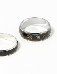 Highlighting celestial silver symbol mood ring set with black and gold detailing close up view - link has visual effect only