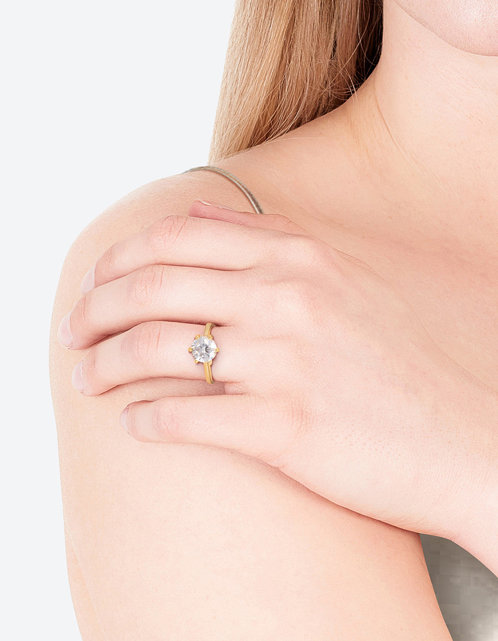 Elegant gold plated round cubic zirconia ring worn on finger showcasing clear details on finger view