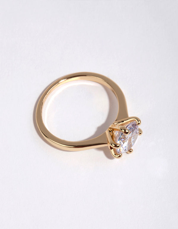 Crafted from gold plated material this round cubic zirconia ring highlights clear stone detailing side detail view