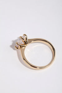 Crafted from gold plated material this round cubic zirconia ring highlights clear stone detailing side detail view - link has visual effect only