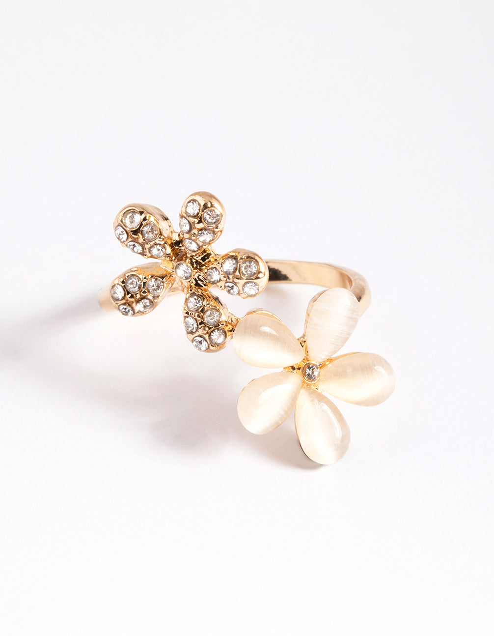 Showcasing a gold diamante and cateye flower ring in statement style front view