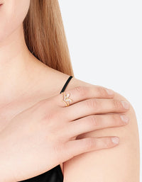 Showcasing a gold plated cubic zirconia butterfly double band ring on finger view - link has visual effect only