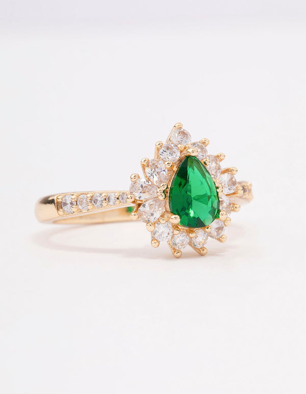 Elegant gold plated regal ring featuring a pear cut cubic zirconia stone in green with clear accents front view