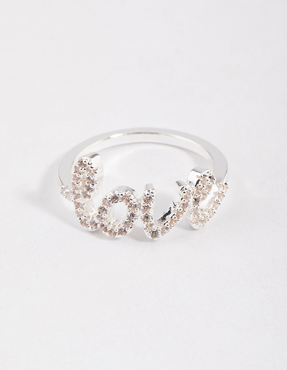 Beautifully crafted silver plated love script ring with dainty styling in clear stone close up view