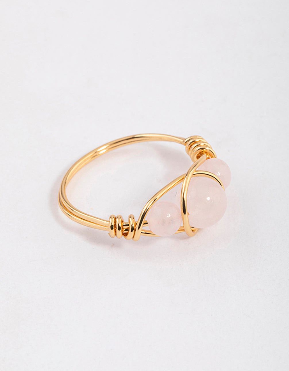 Showcasing a gold plated wrapped triple stone ring with beads in statement style front view