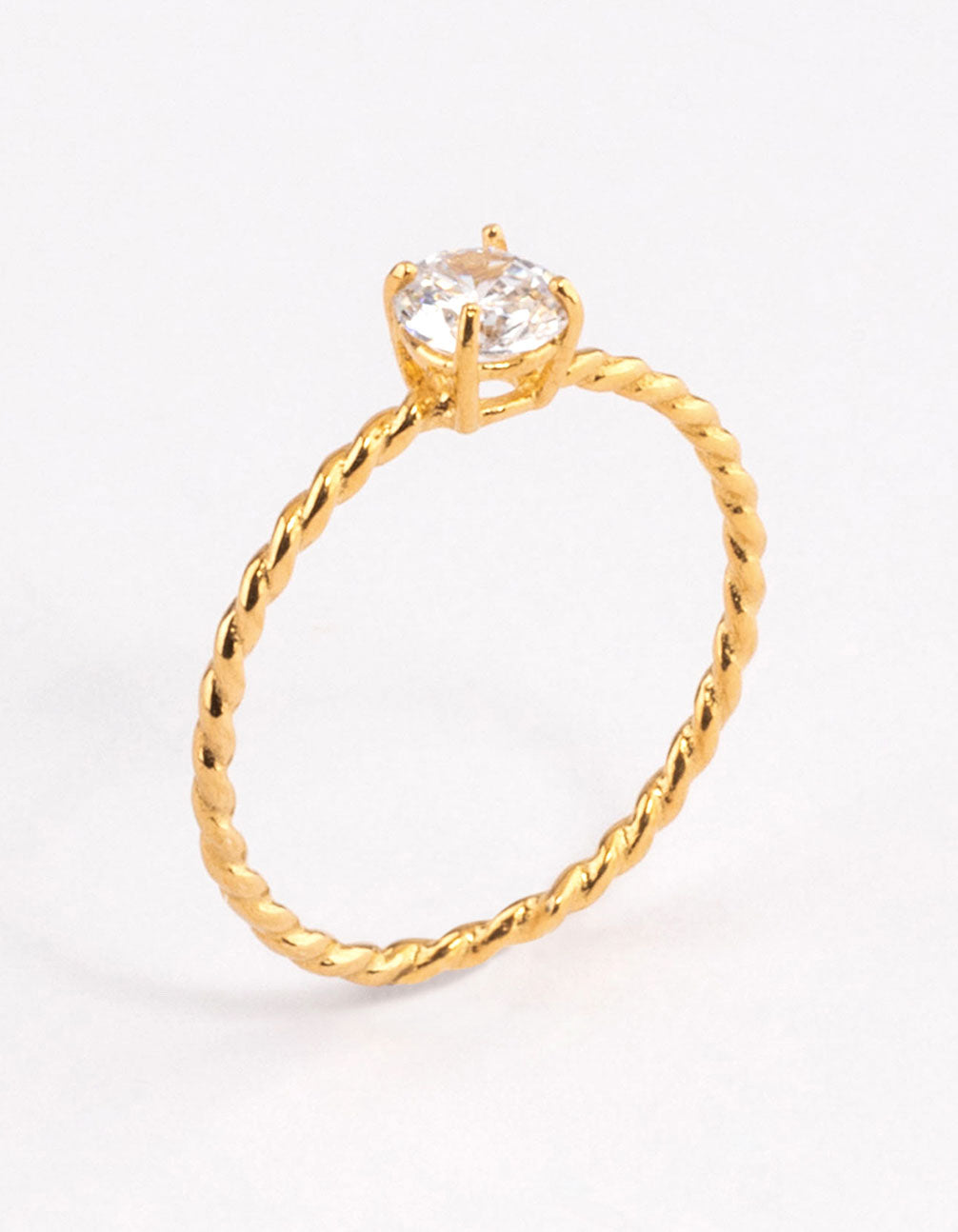 Beautifully crafted gold plated sterling silver cubic zirconia twist engagement ring featuring clear accents close up view