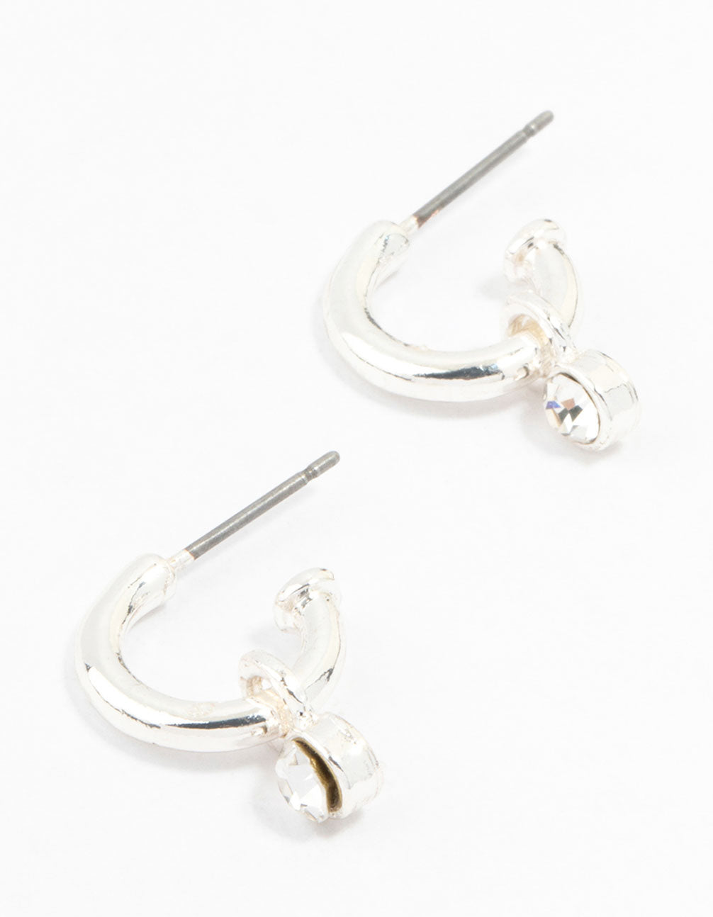 Showcasing simple diamante huggie earrings in silver front view