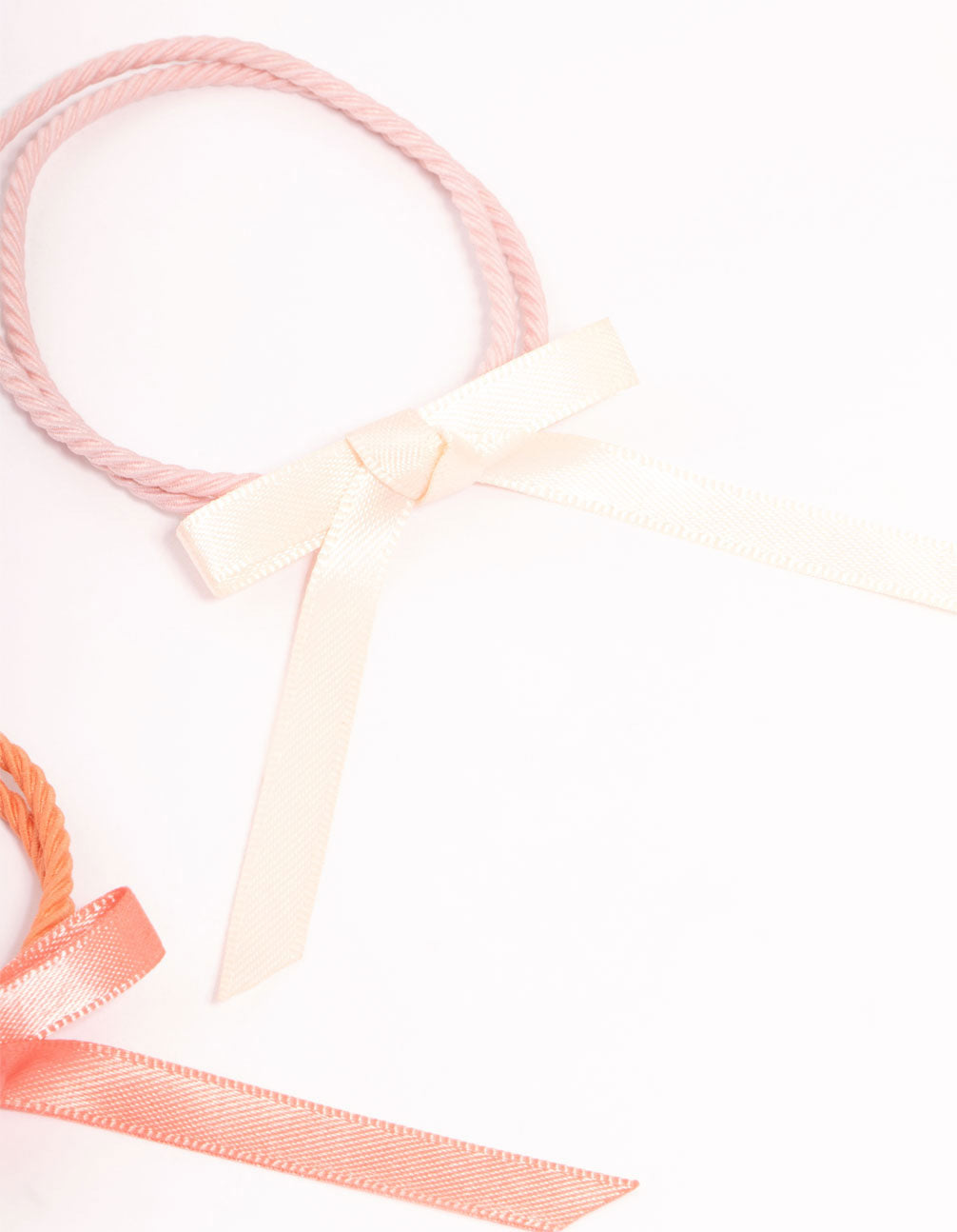 Crafted with thin fabric bow hair ties in a 4-pack displaying solid pink, white, hot pink, and coral hues side view