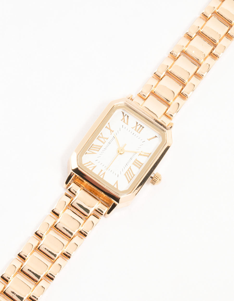 Featuring a women's white dial with roman numerals in a rectangle shape, this gold analog watch with link band strap is crafted for formal occasions watch face detail view