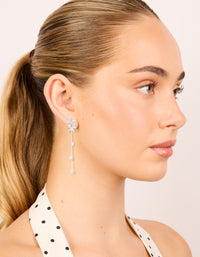 Beautifully designed silver plated cubic zirconia flower station drop earrings with floral charm accents on model view - link has visual effect only