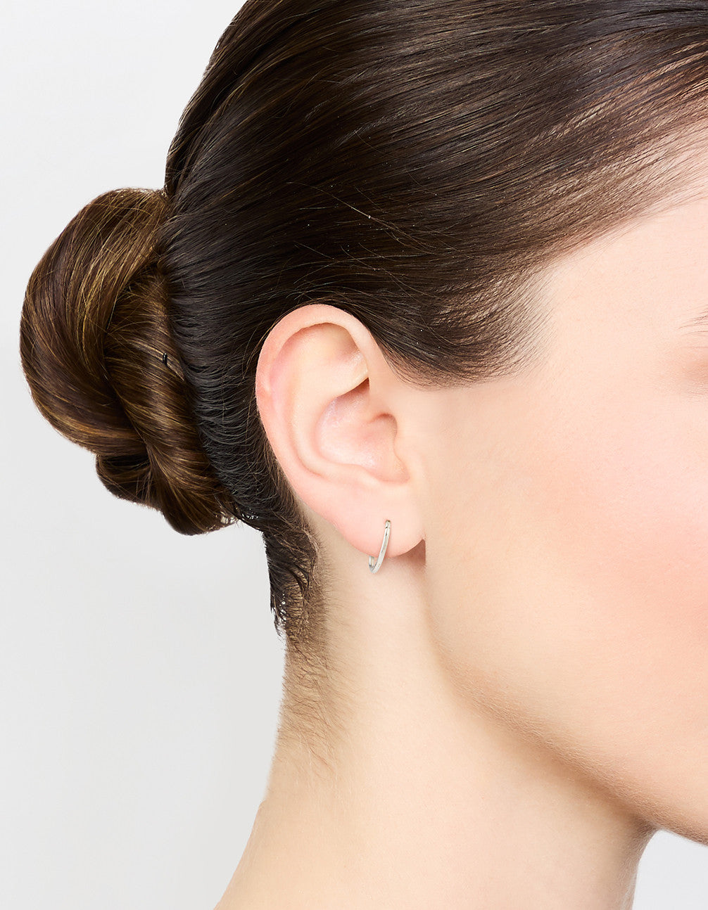 Featuring surgical steel medium sleeper earrings in silver, 10 mm on ear view