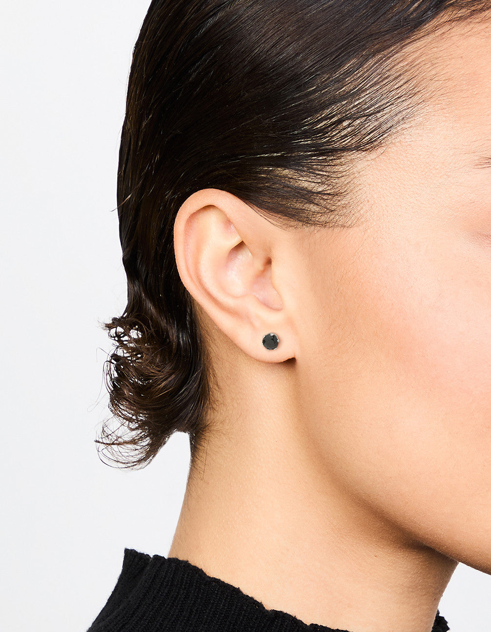 Featuring waterproof black diamante stainless steel stud earrings on ear view