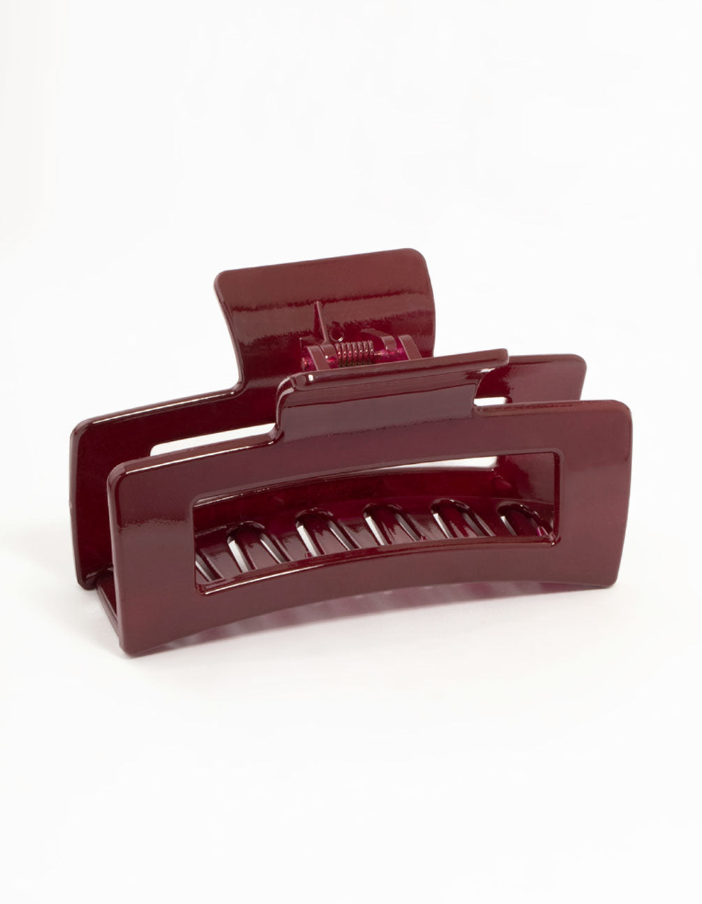 Showcasing a shiny large burgundy coated claw clip in maroon front view