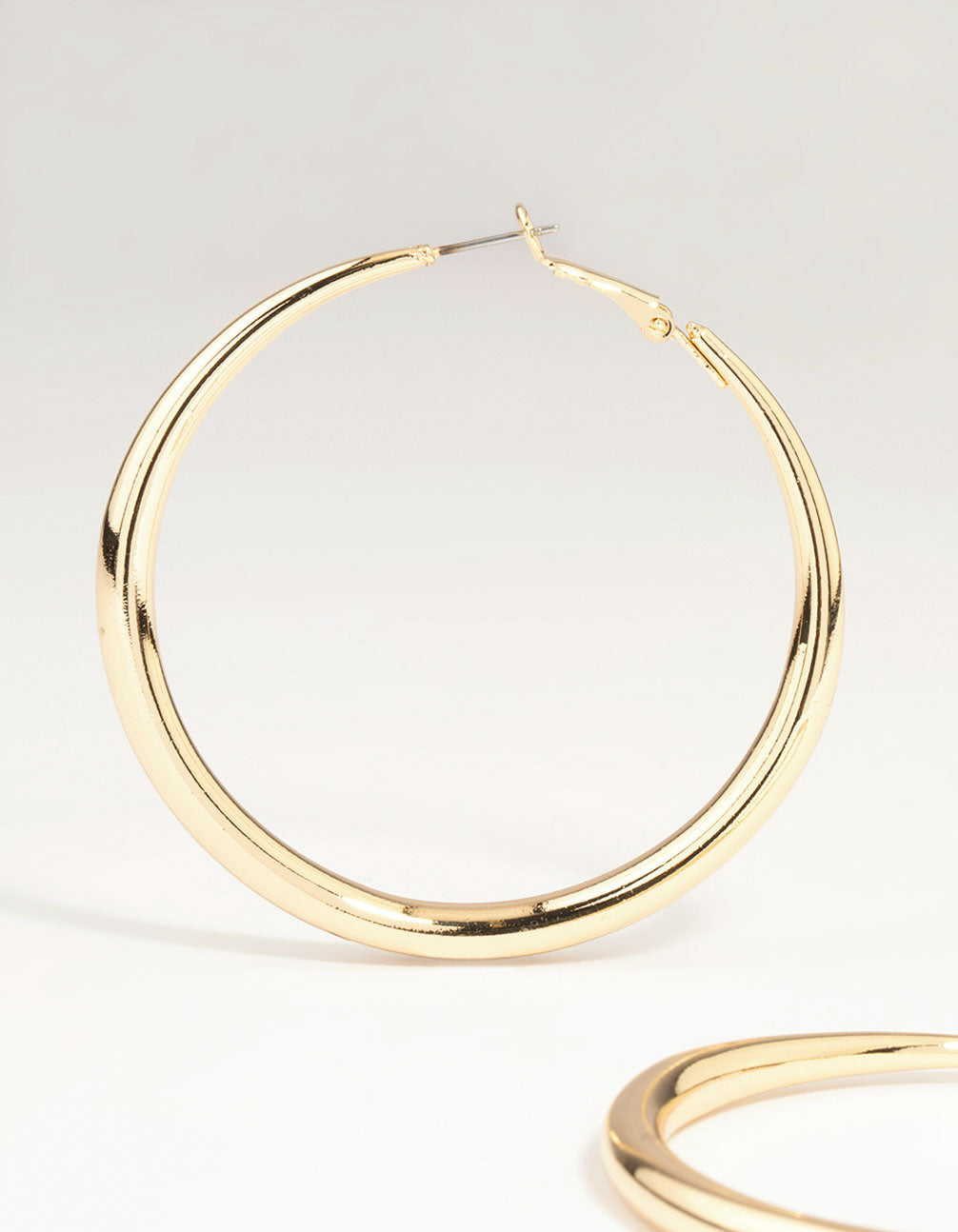 Designed with gold dome hoop earrings with closure showcasing post detail view