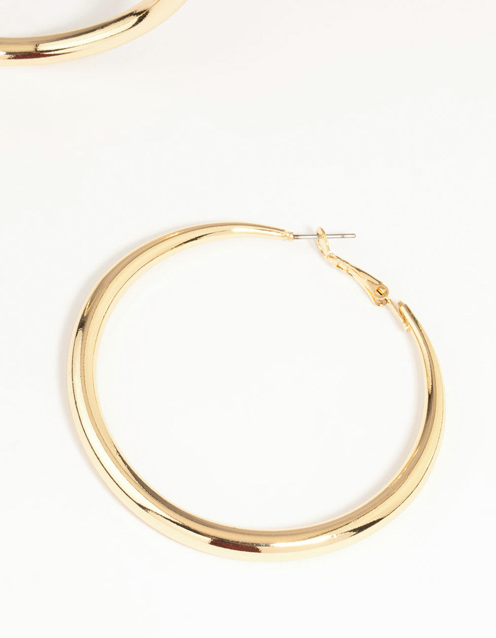 Highlighting gold dome hoop earrings with closure and fastening mechanism close up view