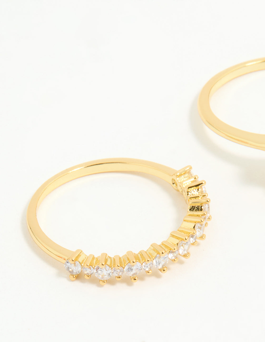 Showcasing gold plated cubic zirconia oval stacking rings in a 3-pack close up view