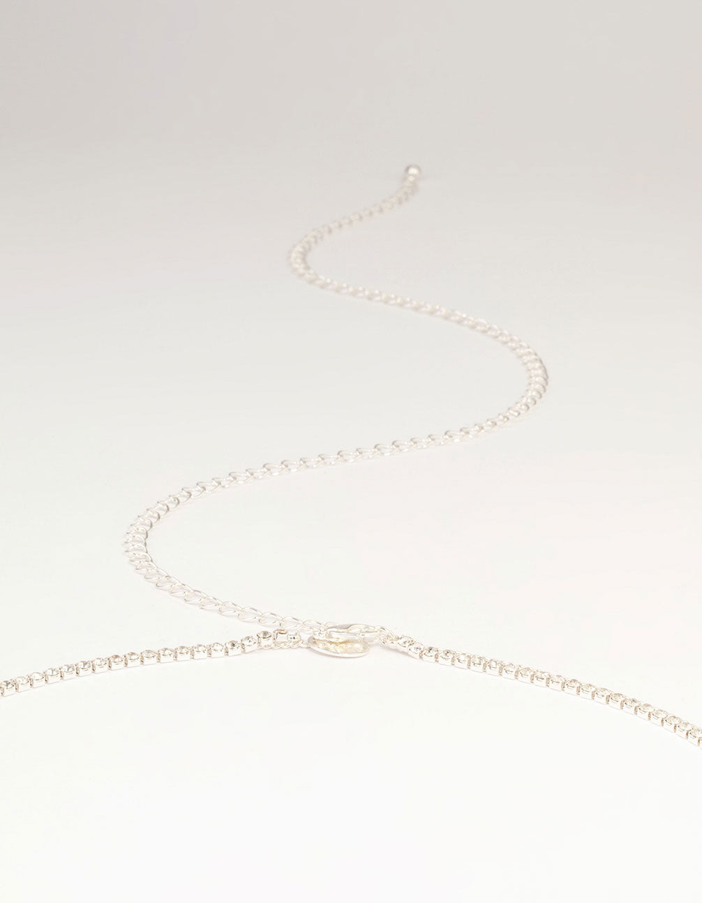 Showcasing a silver diamante cupchain waist chain embellished with beads and waisted shape detail view