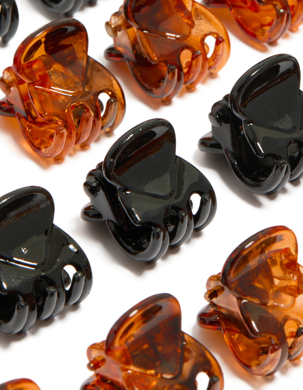 Crafted from solid black and dark orange neutral mini claw clips in a 24-pack detail view