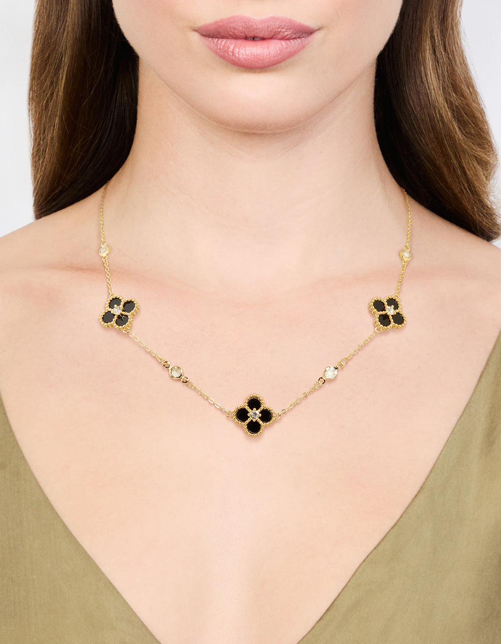 Showcasing gold plated cubic zirconia black flower pendant necklace with floral and crystal details on neck view