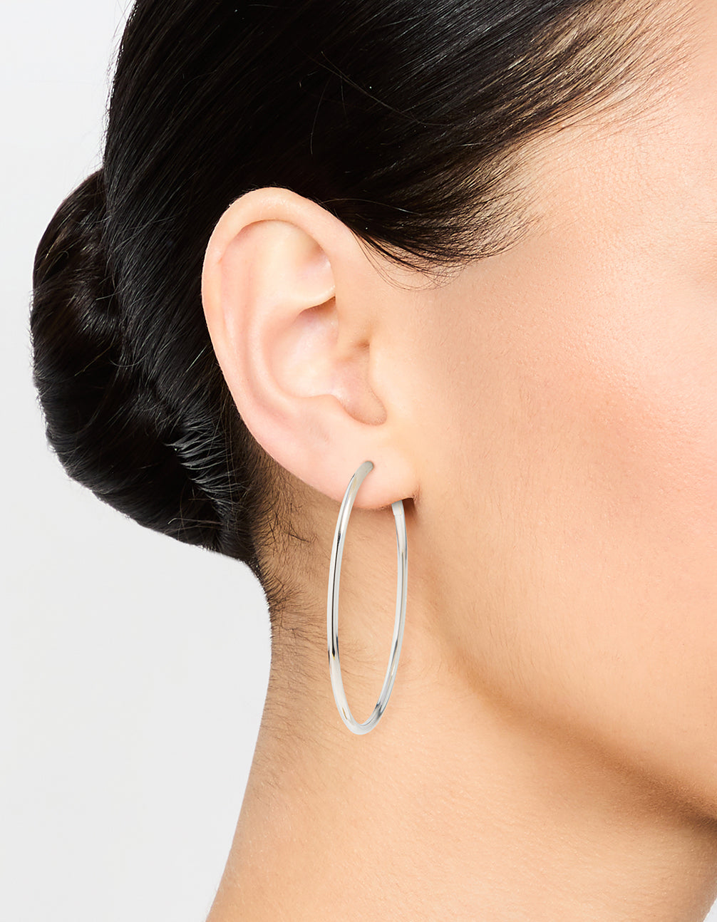 Discover statement hoop earrings, 50 mm in surgical steel with silver finish on ear view