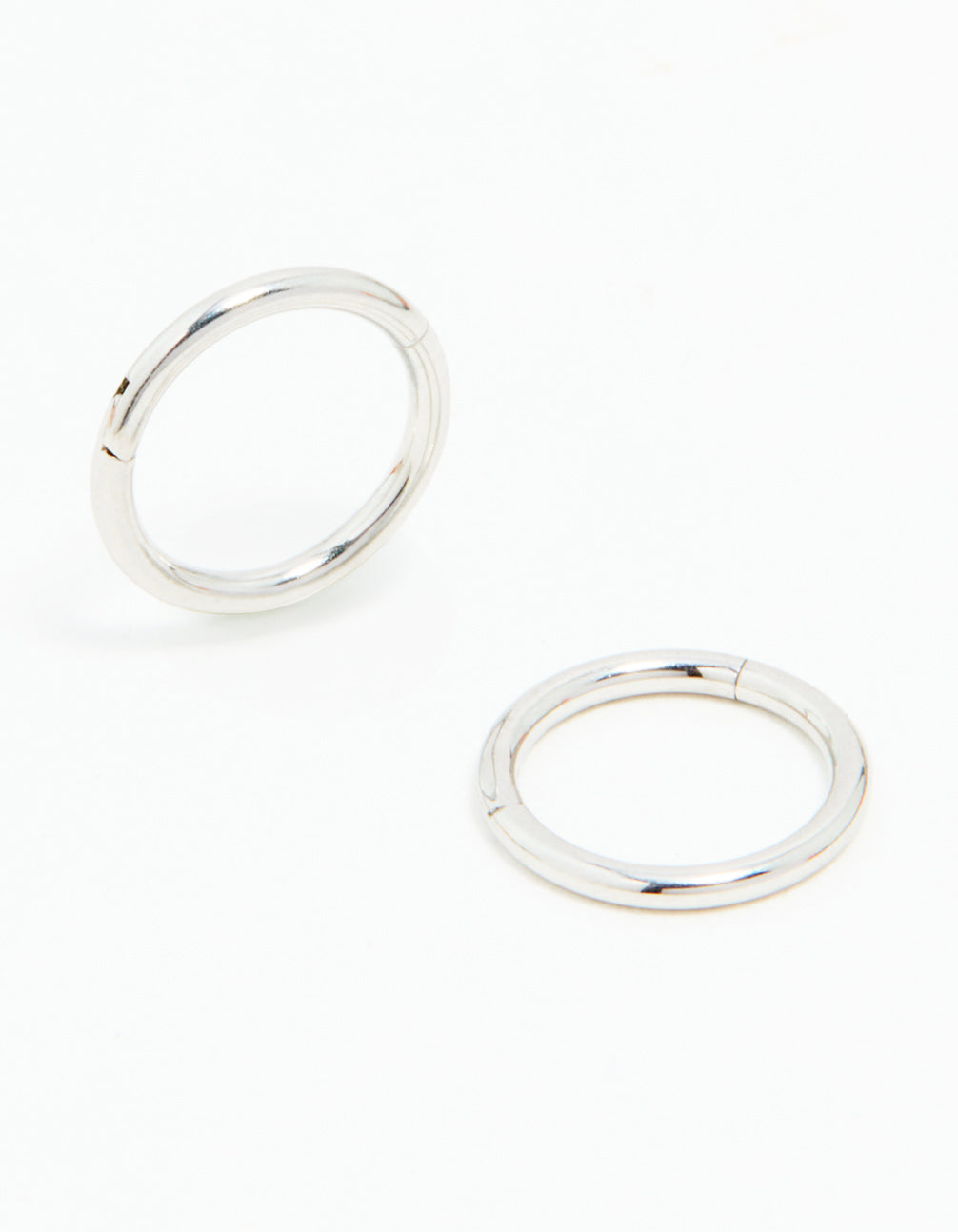 Explore these surgical steel sleeper earrings in 7mm, featuring dainty design with silver finish front view