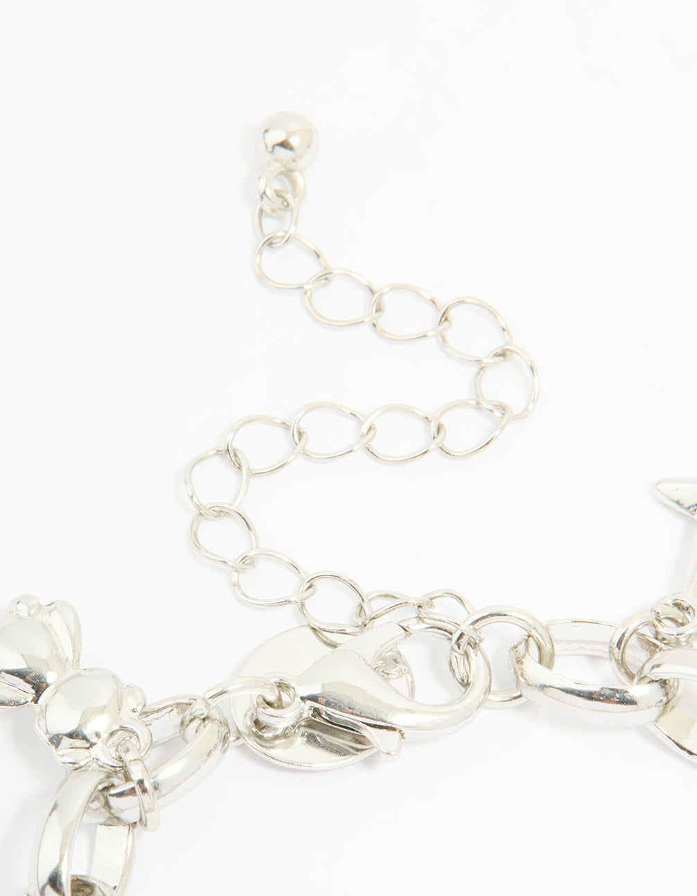 Crafted in silver, this watch and charm bracelet features bow, butterfly, and heart charms with white round dial, number dial look, link band, casual analog design for women, statement style closure detail view