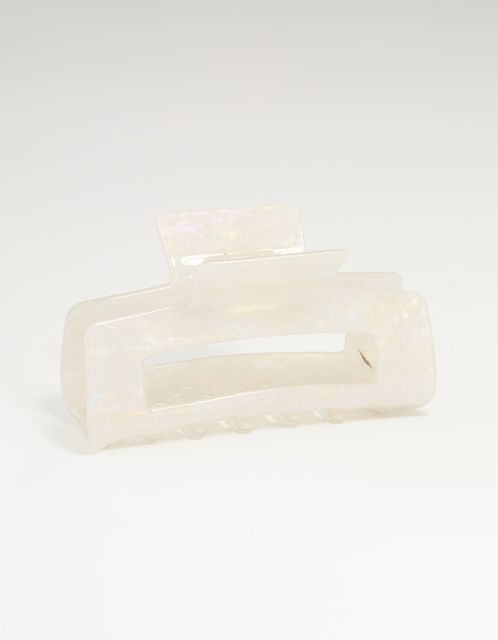 Showcasing a solid print ivory and acrylic rectangle claw clip front view