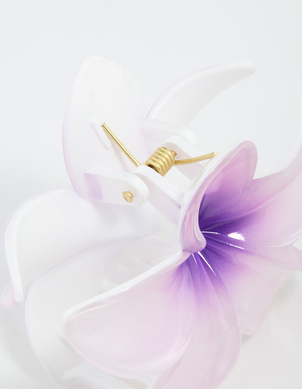 Crafted with purple ombre pearlised frangipani design, this claw clip light pink, white, and gold accents detail view