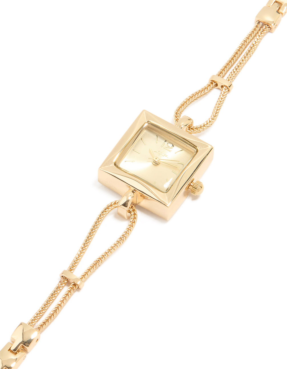 Showcasing a gold tone square dial, toggle chain women's casual analog watch with link band and statement style in gold watch face detail view
