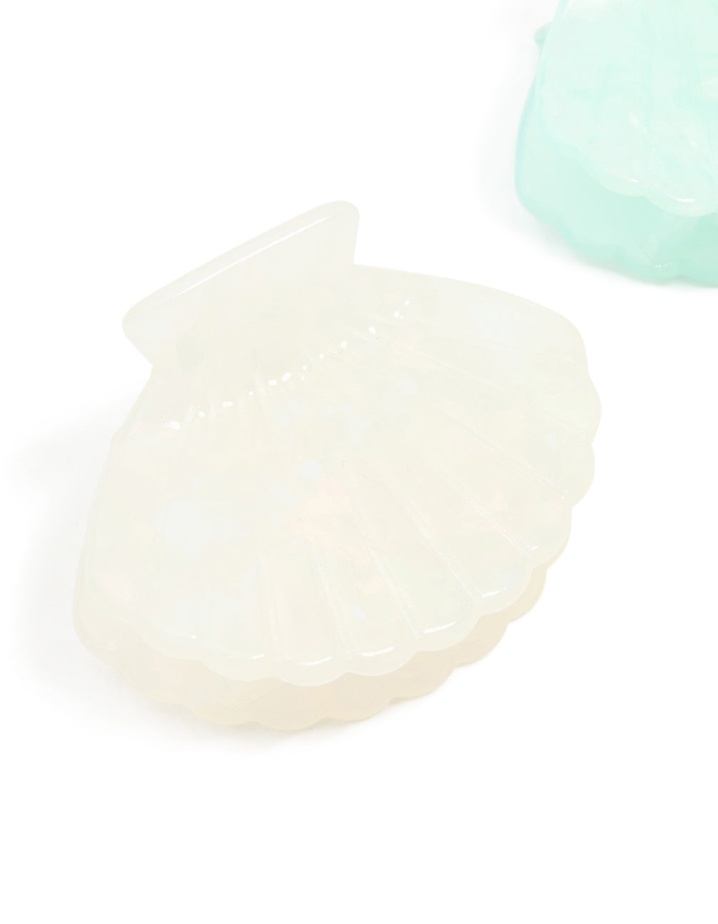 Crafted with ocean-inspired shell design, these solid pale turquoise and ivory claw clips in a 2-pack accessories side view