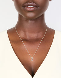Showcasing a sterling silver blue cubic zirconia and starfish pendant necklace with ocean charm details in delicate crystal design on neck view - link has visual effect only