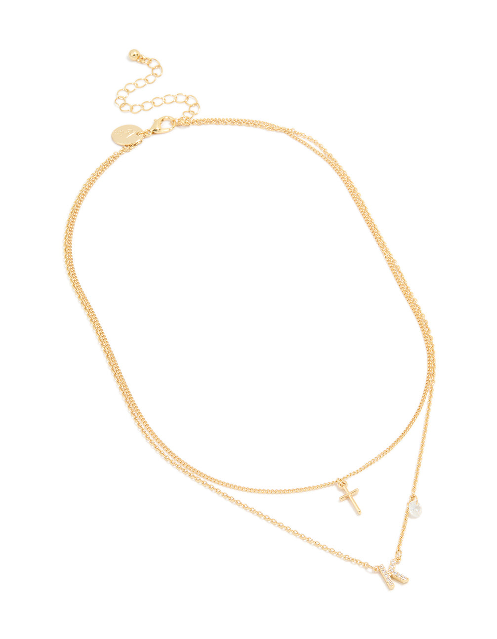 Displaying a layered necklace with cross and letter K charms in gold plated material featuring cubic zirconia with statement style front view