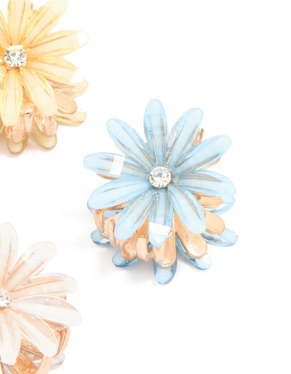 Featuring floral print in pink, light blue, peachpuff, and gold, this mixed daisy facet claw clips 4-pack presents side view