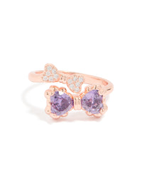 Featuring a charming bow design, this rose gold cubic zirconia ring displays the delicate violet stones and band structure close up view - link has visual effect only