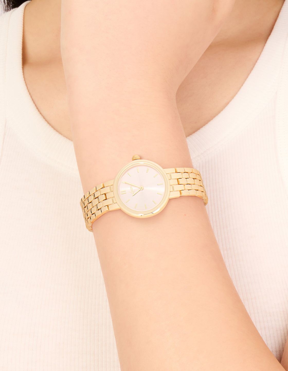 Showcasing a pink dial round face watch designed for women with casual analog style and link band in gold strap color on wrist view