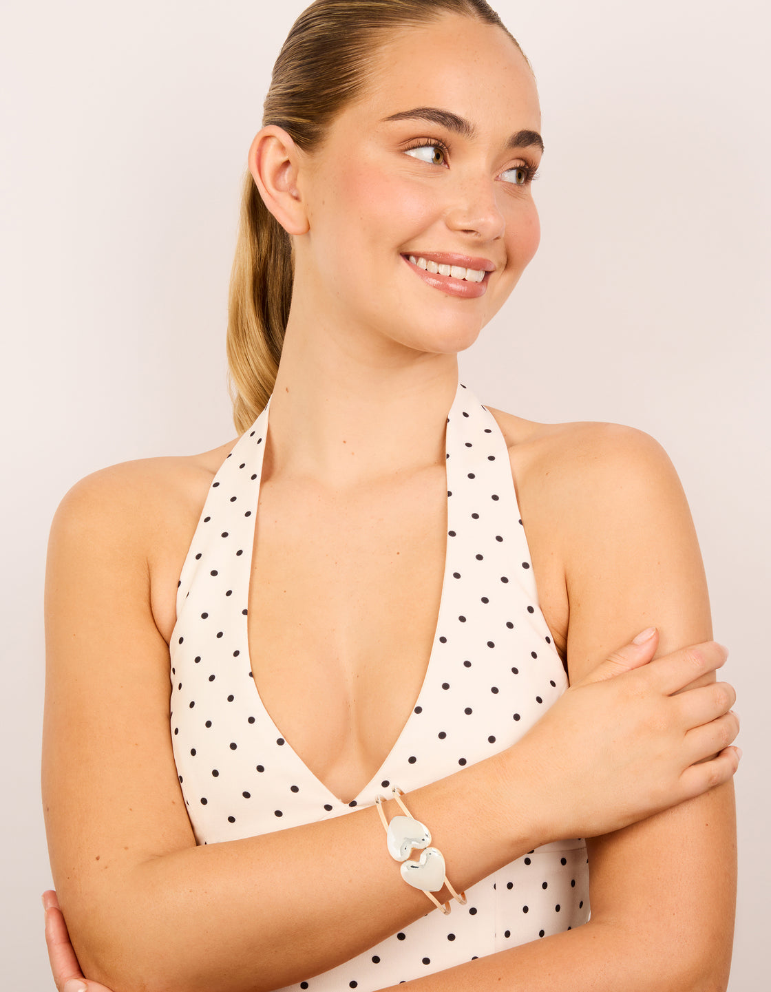 Designed with a heart hinged bangle crafted from mixed metals on model view
