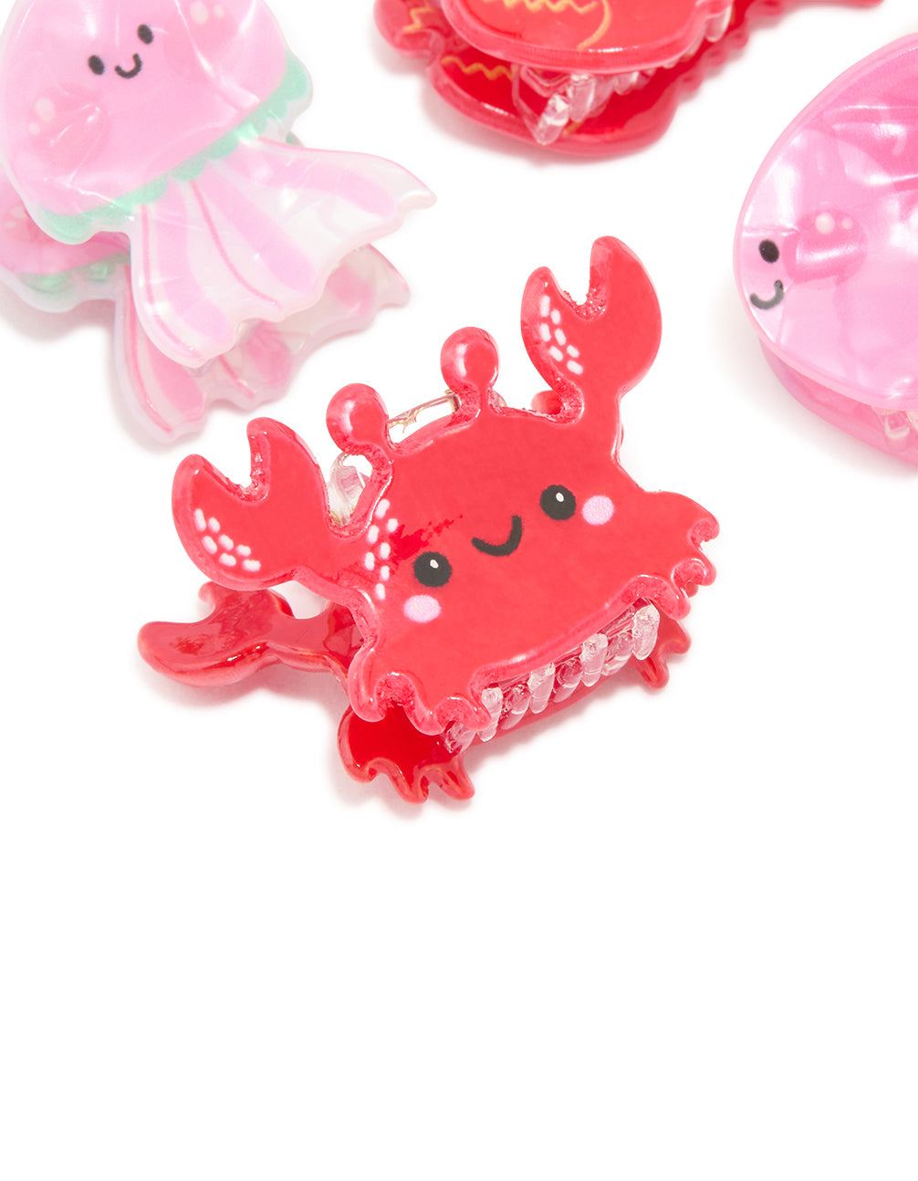 Crafted from acrylic, sea life claw clips 4-pack with ocean feature in pink, coral and black detail view